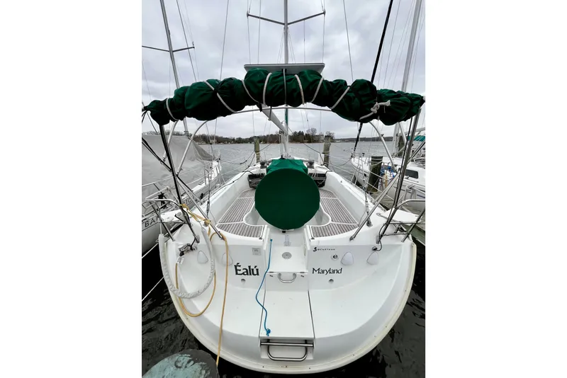 Slide: The Image of 1995 Beneteau Oceanis 351 sailboat docked, rear view with green covers, Maryland. - 7