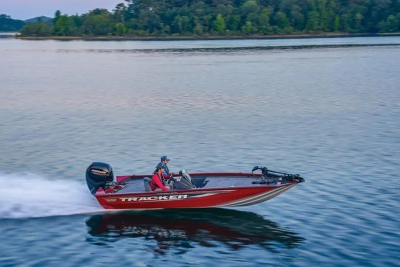 Slide: The Image of 2025 Tracker Pro Team 195 Tournament Edition boat speeding on a serene lake. - 11