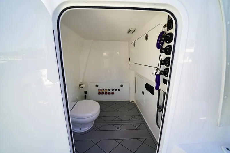 Slide: The Image of 2024 Invincible 35 Catamaran interior with modern bathroom and control panel features. - 14