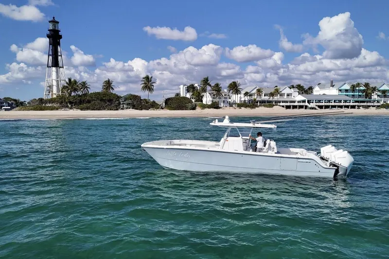 Slide: The Image of Aerial view of 2024 Invincible 35 Catamaran on clear green water. - 38