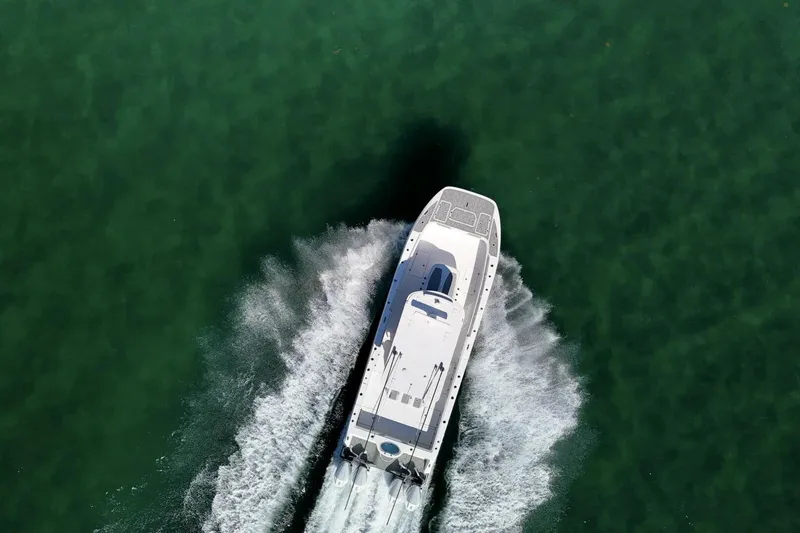 Slide: The Image of Overhead view of 2024 Invincible 35 Catamaran on clear green water. - 40