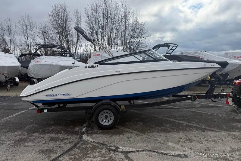 Slide: The Image of 2026 Yamaha Boats SX190 on trailer, parked outdoors under cloudy sky. - 3