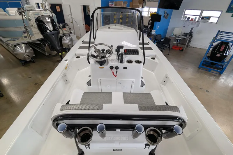 Slide: The Image of 2026 Frontier 2104 boat interior with steering console and seating in showroom. - 16