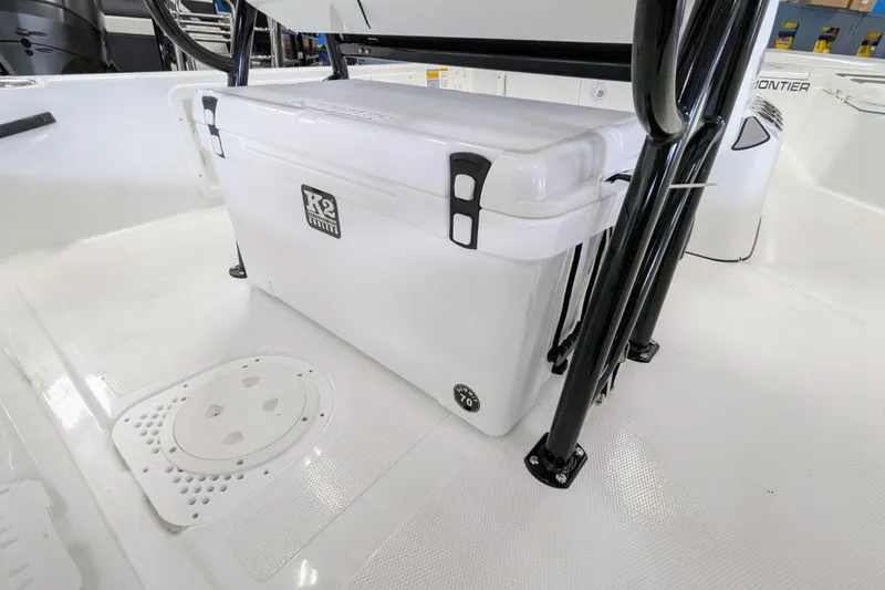 Slide: The Image of White K2 cooler on 2026 Frontier 2104 boat deck, secured with black metal frame. - 17