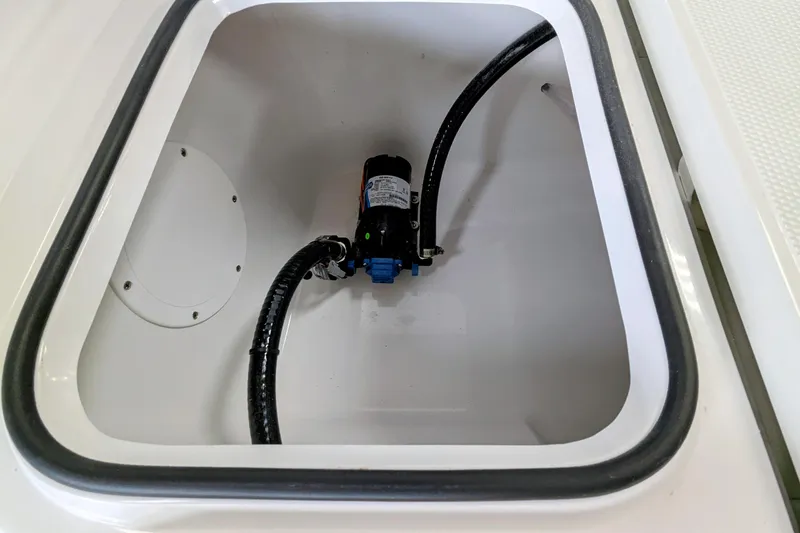Slide: The Image of Open compartment of 2026 Frontier 2104 boat showing internal pump and wiring. - 19