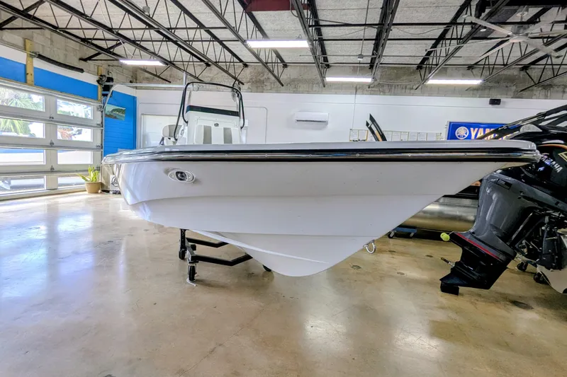 Slide: The Image of 2026 Frontier 2104 boat displayed in a showroom with modern interior. - 2