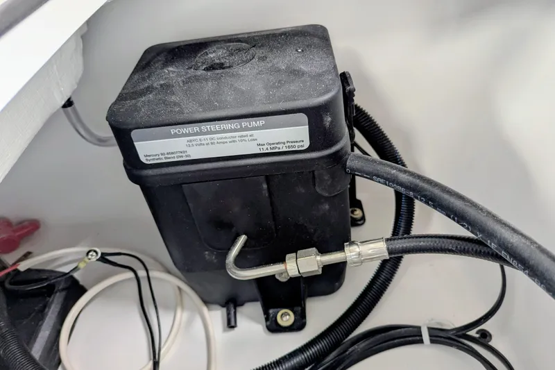 Slide: The Image of Power steering pump in Frontier 2104, 2026 model, with connected hoses and wiring. - 21