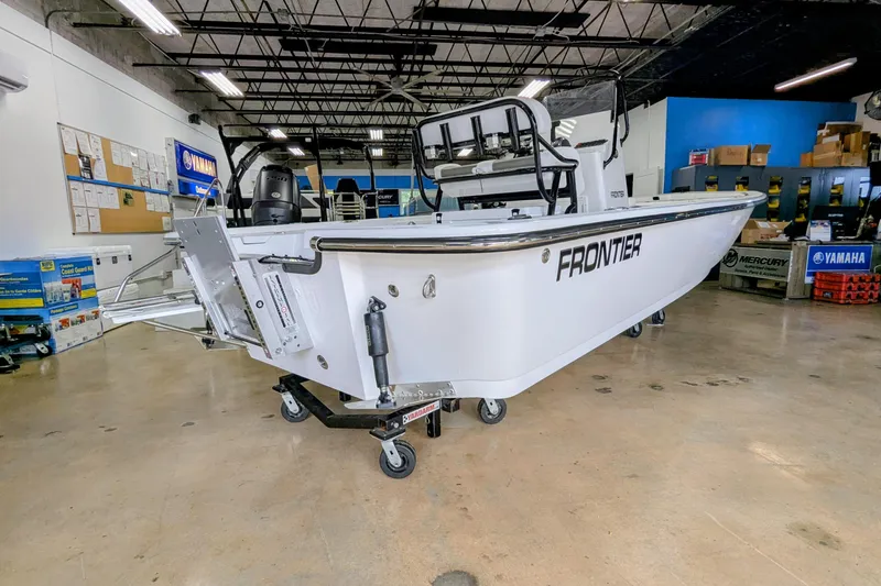 Slide: The Image of 2026 Frontier 2104 boat displayed in showroom with Yamaha and Mercury branding. - 5