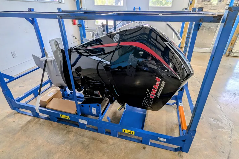 Slide: The Image of Frontier 2104 2026 outboard motor in blue frame, indoor setting. - 6