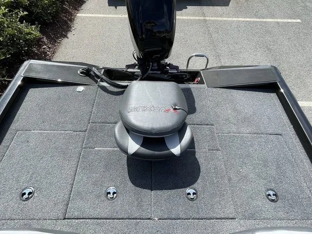 Slide: The Image of 2023 Vexus AVX181 boat deck with seat and motor, featuring gray carpeting. - 13