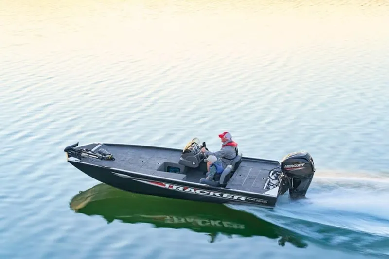 Slide: The Image of 2025 Tracker Pro 170 boat cruising on calm water with two passengers. - 13