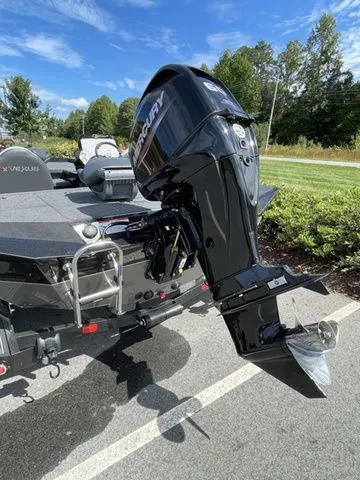 Slide: The Image of 2023 Vexus AVX181 boat with Mercury outboard motor, parked on a sunny day. - 3