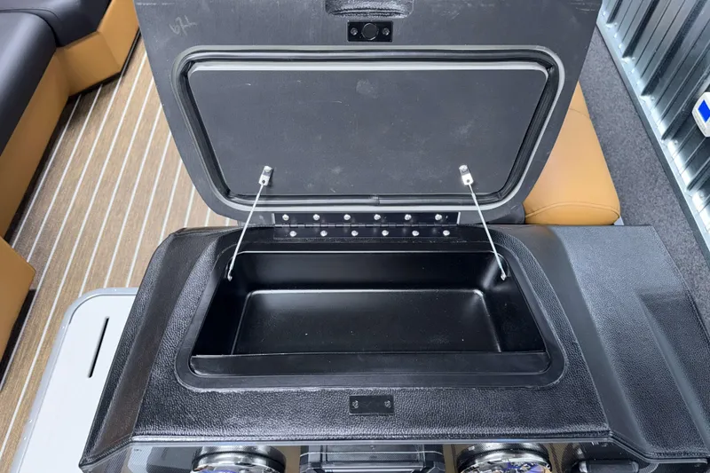 Slide: The Image of Open storage compartment on 2026 Premier 230 SunSation RF Tritoon boat. - 13