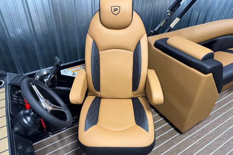 Slide: The Image of Luxurious captain's chair in 2026 Premier 230 SunSation RF Tritoon boat interior. - 14