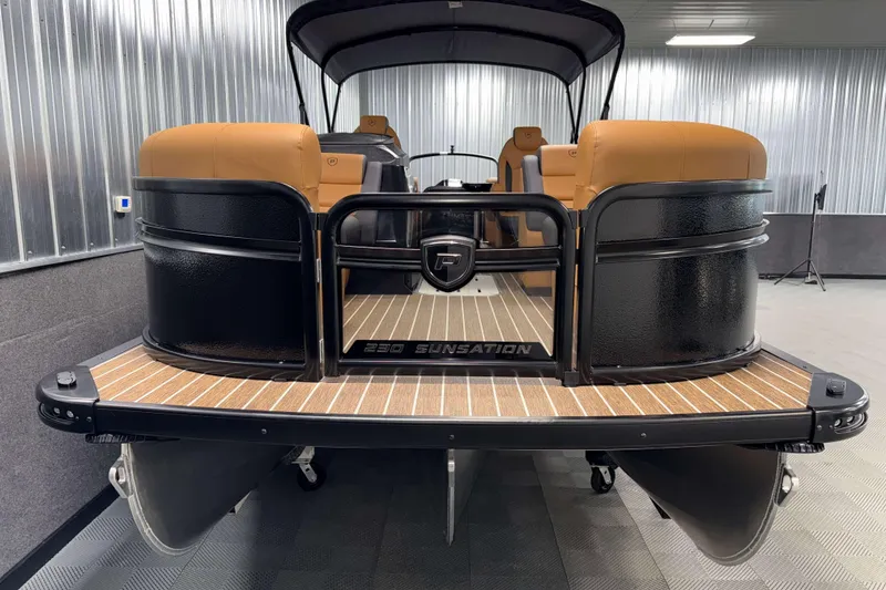 Slide: The Image of 2026 Premier 230 SunSation RF Tritoon in showroom, featuring sleek design and luxury seating. - 2