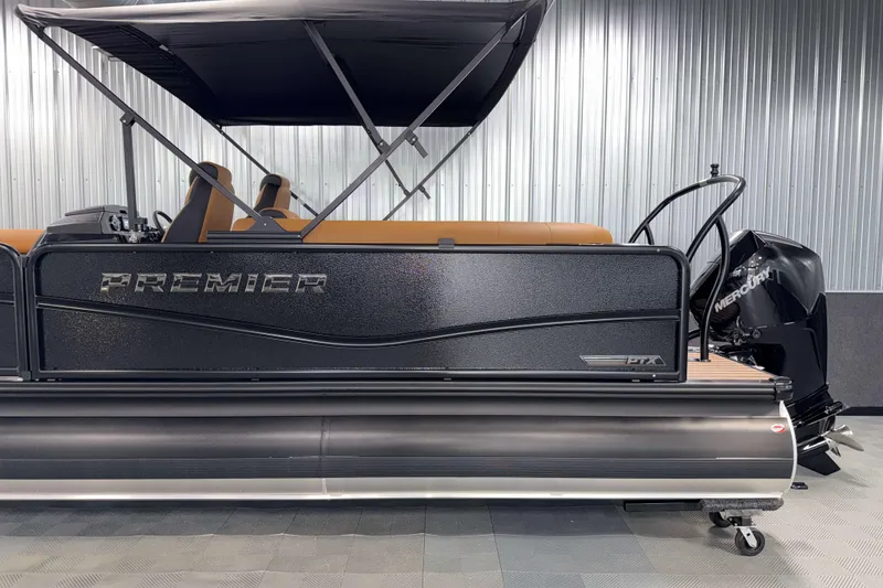 Slide: The Image of 2026 Premier 230 SunSation RF Tritoon with black exterior and Mercury engine in showroom. - 5