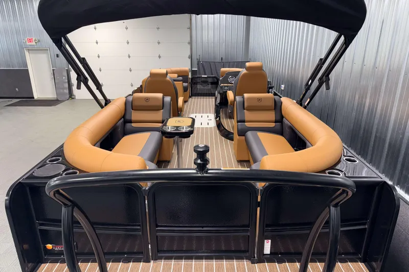Slide: The Image of 2026 Premier 230 SunSation RF Tritoon with luxurious tan seating and sleek design. - 8