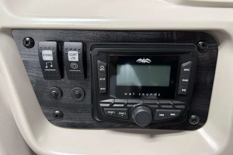 Slide: The Image of Control panel of 2026 SunChaser Vista 18 Fish with stereo and lighting switches. - 10