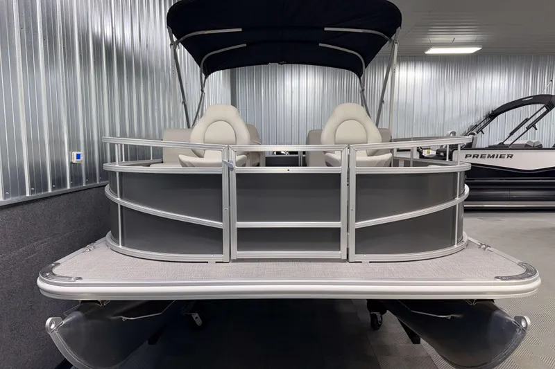 Slide: The Image of 2026 SunChaser Vista 18 Fish pontoon boat in a showroom, front view. - 19