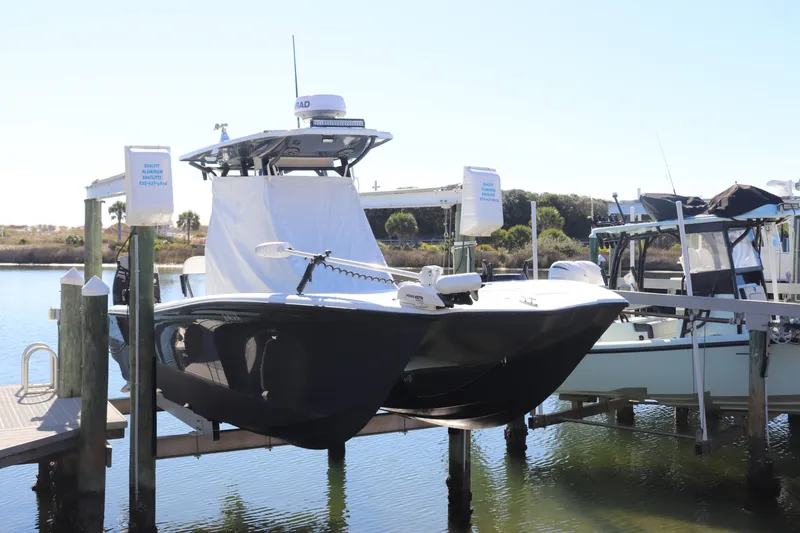 The Image of 2021 Costa Custom Boats 26 on lift at marina, ready for water adventure. - 0