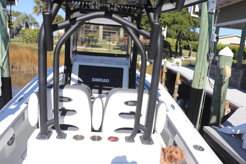 Slide: The Image of 2021 Costa Custom Boats 26 with Simrad display, docked with a dog onboard. - 1