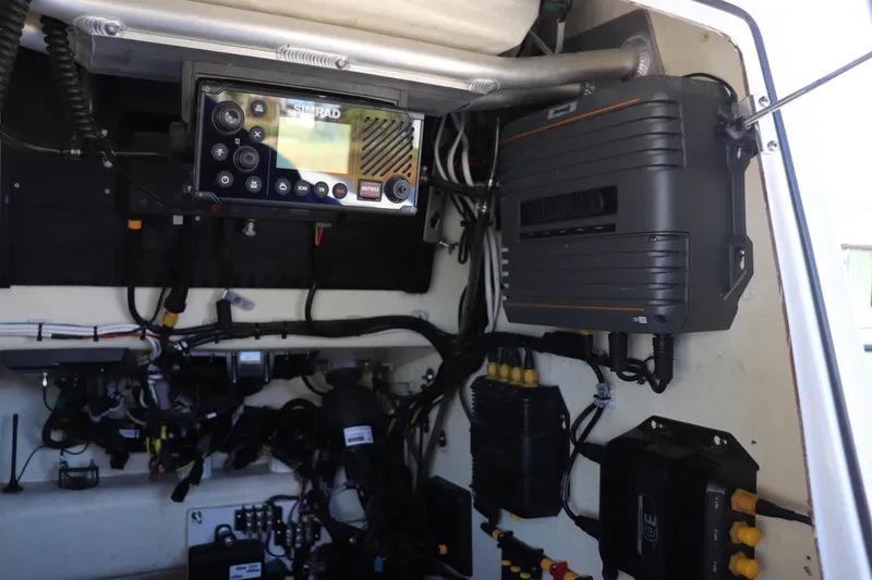 Slide: The Image of 2021 Costa Custom Boats 26 docked, featuring spacious deck and outboard motor. - 11