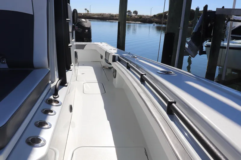 Slide: The Image of Open storage compartment on 2021 Costa Custom Boats 26, featuring ropes and a key. - 12