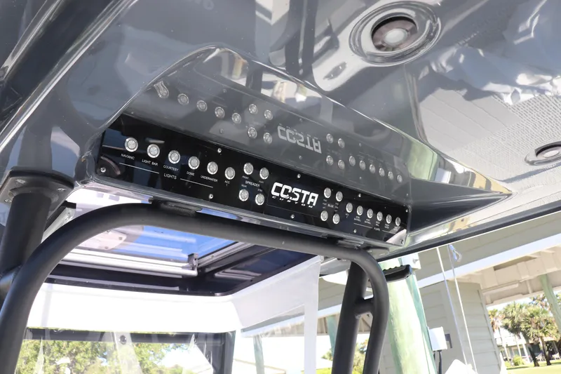 Slide: The Image of 2021 Costa Custom Boats 26, open storage compartment on deck, white finish. - 23