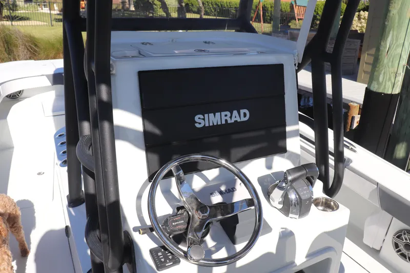 Slide: The Image of 2021 Costa Custom Boats 26 interior with control panel and seating. - 24