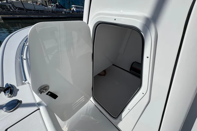 Slide: The Image of 2024 Sportsman Masters 247 Bay Boat storage compartment open at dock. - 12