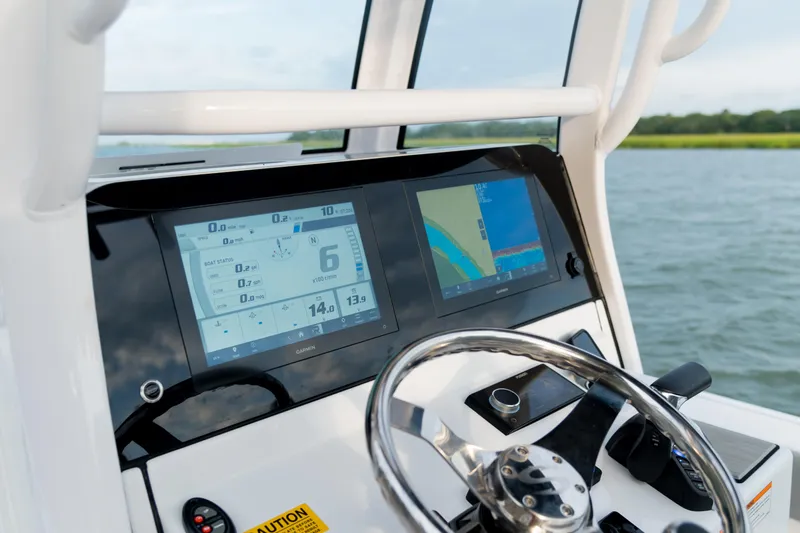 Slide: The Image of 2024 Sportsman Masters 247 Bay Boat docked at marina, showcasing sleek design and seating. - 3