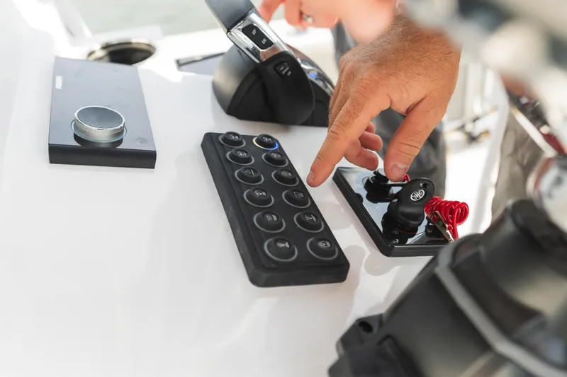 Slide: The Image of 2024 Sportsman Masters 247 Bay Boat with white seating and storage compartments. - 4