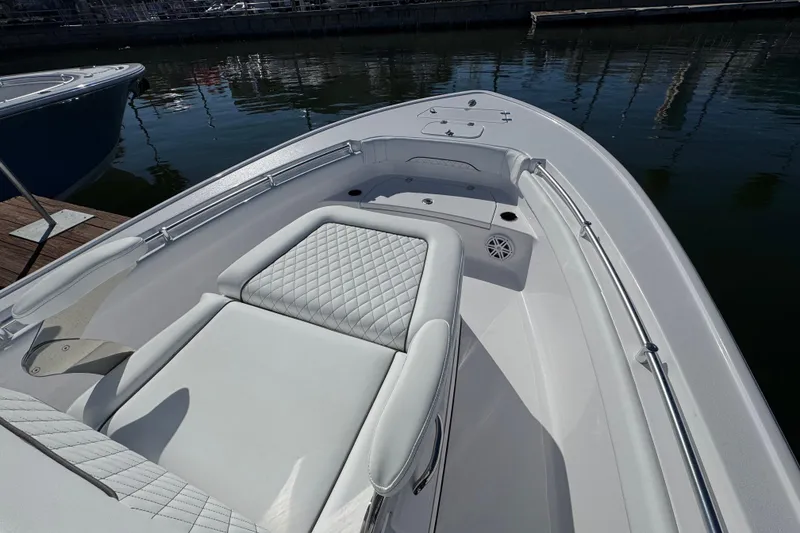 Slide: The Image of 2024 Sportsman Masters 247 Bay Boat with luxurious seating and sleek design in a marina. - 7