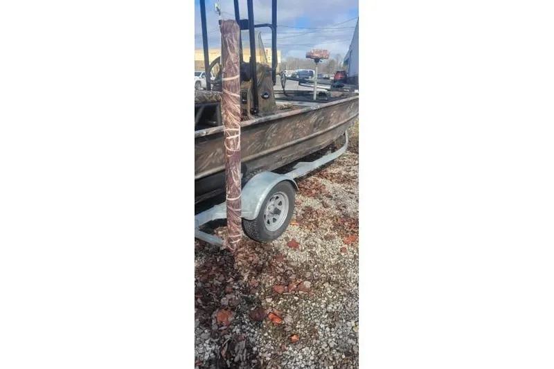 Slide: The Image of 2020 G3 Gator Tough 17 CC boat on trailer, parked on gravel. - 6