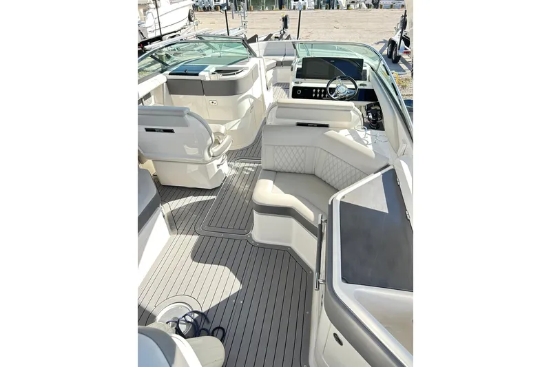 Slide: The Image of 2020 Sea Ray SLX 310 boat interior with luxurious seating and modern dashboard. - 12