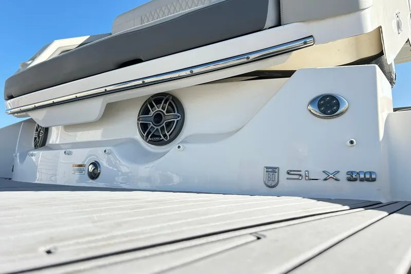 Slide: The Image of 2020 Sea Ray SLX 310 boat rear view with speakers and logo. - 16