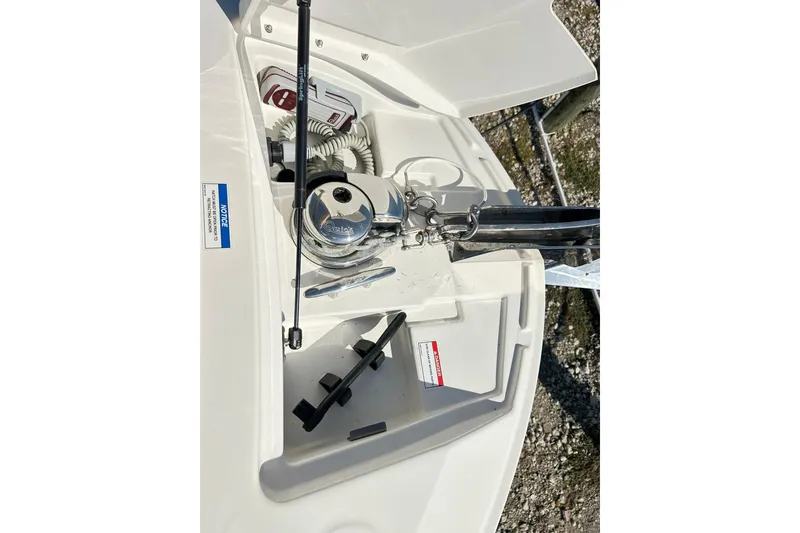 Slide: The Image of 2020 Sea Ray SLX 310 boat anchor compartment with winch and storage. - 21