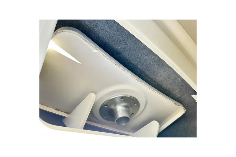 Slide: The Image of 2020 Sea Ray SLX 310 boat interior detail, featuring a storage compartment with a mounted fixture. - 24