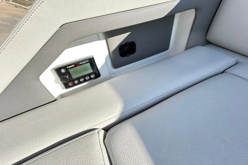 Slide: The Image of 2020 Sea Ray SLX 310 interior with Fusion stereo system and cushioned seating. - 32