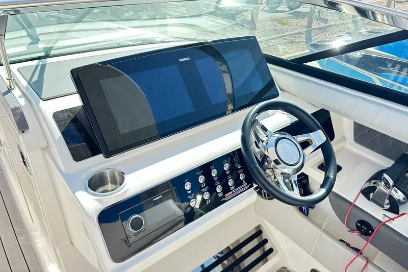 Slide: The Image of 2020 Sea Ray SLX 310 helm with modern controls and navigation display. - 7