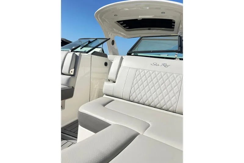 Slide: The Image of 2020 Sea Ray SLX 310 boat interior with luxurious seating and open sunroof. - 9