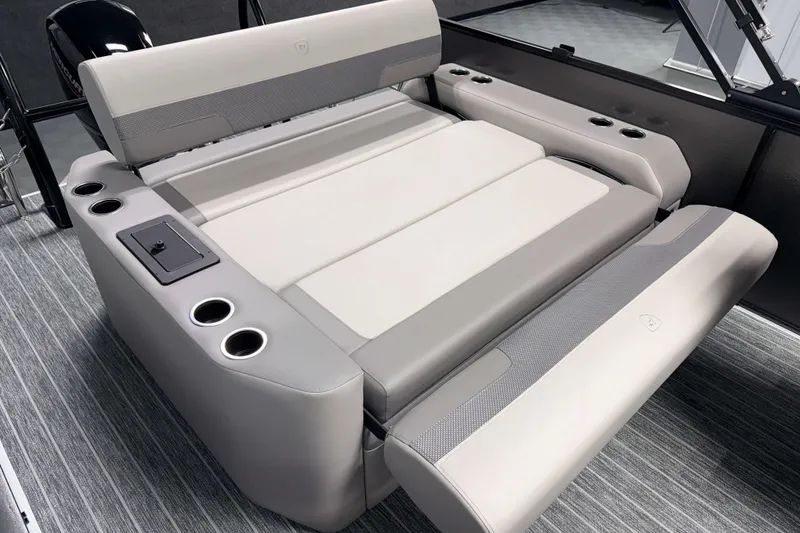 Slide: The Image of 2026 Premier 230 Sunsation RL Tritoon interior seating with cup holders and modern design. - 12