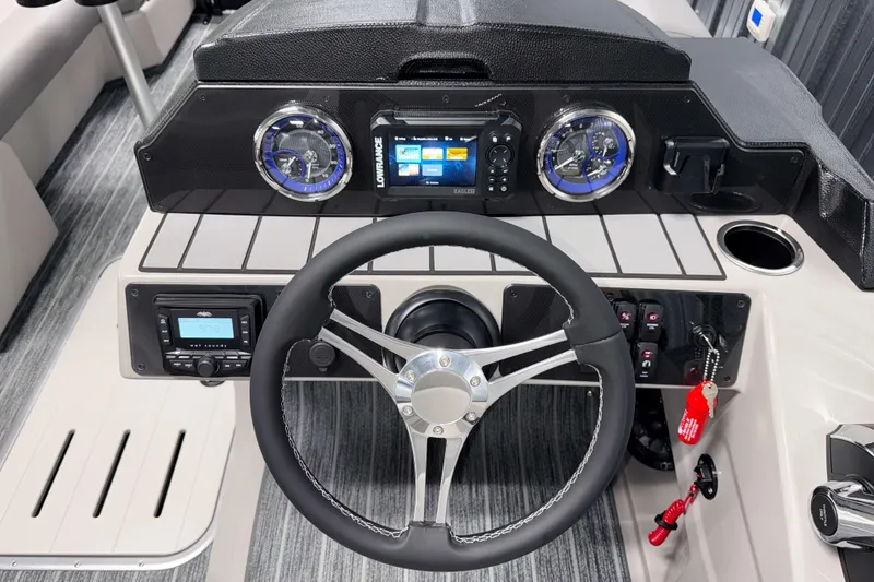 Slide: The Image of 2026 Premier 230 Sunsation RL Tritoon dashboard with steering wheel and modern controls. - 14