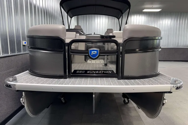 Slide: The Image of 2026 Premier 230 Sunsation RL Tritoon boat in showroom, front view. - 2