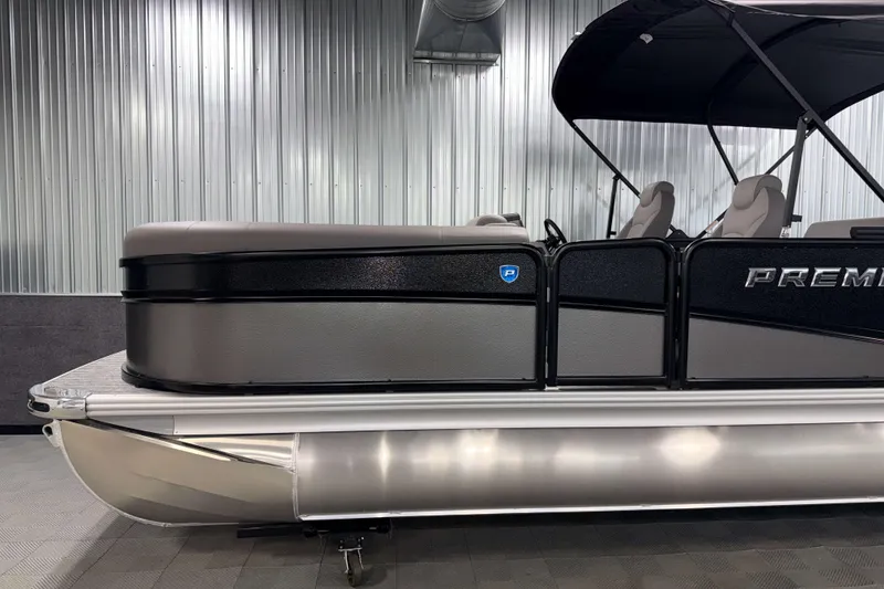 Slide: The Image of 2026 Premier 230 Sunsation RL Tritoon in showroom, side view with sleek design. - 4