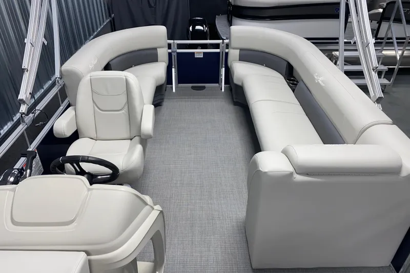 Slide: The Image of 2026 SunChaser Vista 20 LR pontoon boat interior with plush seating and steering console. - 9