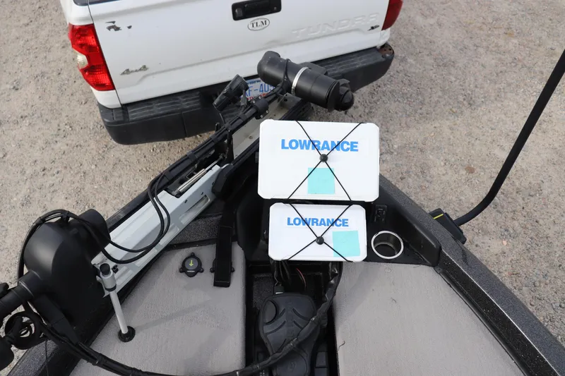 Slide: The Image of Boat with Lowrance equipment and a 2020 Phoenix 21 PHX model near a white truck. - 2