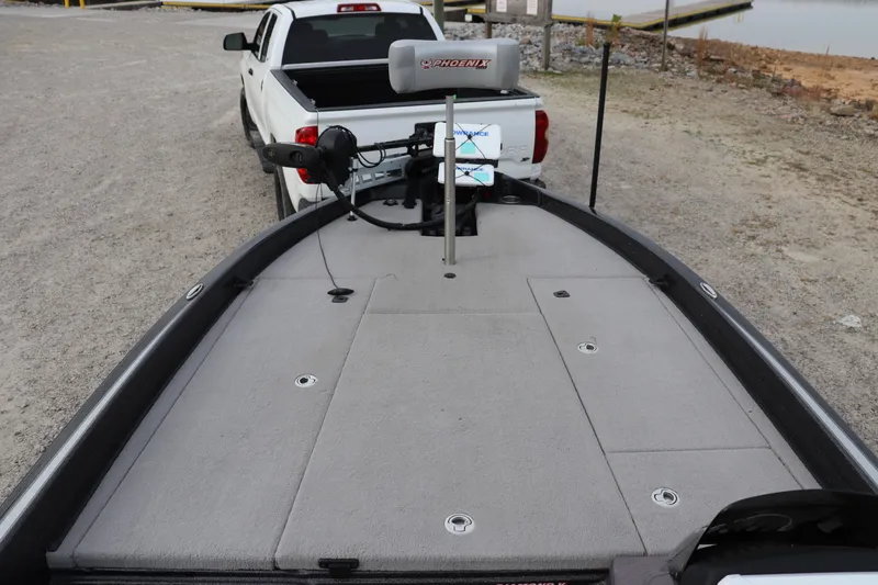 Slide: The Image of 2020 Phoenix 21 PHX boat on trailer, parked near a lake. - 3