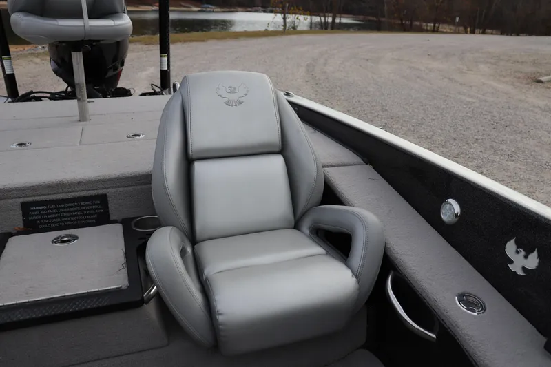 Slide: The Image of 2020 Phoenix 21 PHX boat with gray leather seat, parked near a lake. - 4