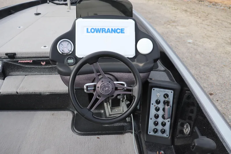 Slide: The Image of 2020 Phoenix 21 PHX boat dashboard with Lowrance display and steering wheel. - 6